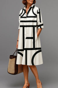 Robe midi chemise blanche à rayures et formes noires, col, boutons, manches 3/4.