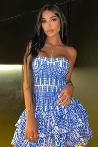 Robe courte à volants bleue et blanche, buste smocké sans manches.