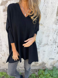 Pull léger col rond noir, manches trois-quarts, coupe ample en maille douce.