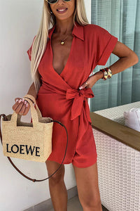 Robe courte rouge à col chemise, manches courtes, ceinture nouée à la taille.
