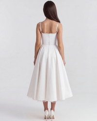 Robe ivoire vue de dos, bretelles fines et jupe évasée mi-longue