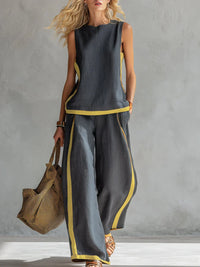 Ensemble deux pièces gris anthracite : débardeur sans manches et pantalon ample à bordures jaunes.