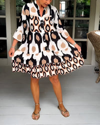 Robe bohème ample, imprimé géométrique beige-noir, manches évasées, col V.