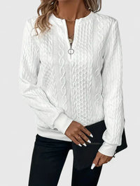 Pull à zip discret blanc, détails du zip et texture en relief torsadé