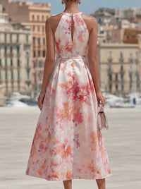 Robe midi florale rose, dos nu en V, encolure halter et jupe ample