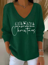 Pull de fêtes vert à encolure V, motif sapins et texte de Noël brodés blanc.