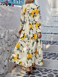 Robe longue imprimée fleurs jaunes et vertes, manches longues évasées, taille froncée