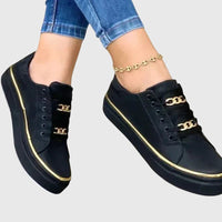 Chaussures orthopédiques noires à lacets, liseré doré et empiècement chaînette