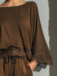 Ensemble nuisette en satin sombre, manches amples et dentelle florale au poignet
