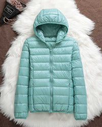 Veste imperméable à capuche matelassée turquoise, zip central.