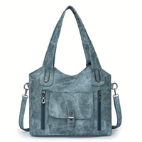 Sac à main vintage bleu avec bandoulière, poche avant à rabat et zips latéraux.