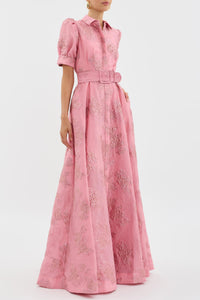 Robe rose à manches bouffantes et ceinture, motif floral sur toute la surface.