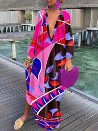 Robe longue à col en V rose et multicolore à motif graphique, manches longues amples.