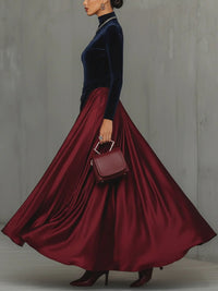 Robe en velours bleu nuit avec jupe évasée drapée rouge bordeaux, manches longues
