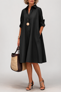 Robe-chemise noire à col, manches longues, boutonnage, coupe mi-mollet.