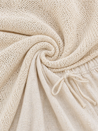 Tissu de l’ensemble beige clair : maille ajourée et bord élastique à cordon