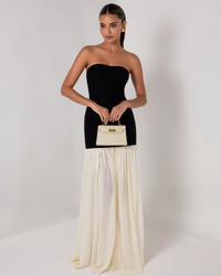 Robe longue sans manches : buste noir et jupe longue plissée ivoire