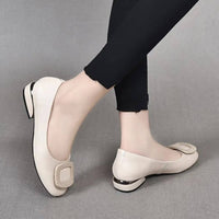 Chaussures orthopédiques en cuir beige, talon petit et bride décorative.