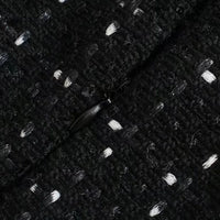 Tissu noir texturé à motifs fins, aspect chiné et maille serrée