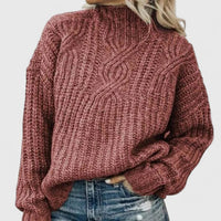 Pull à grosses torsades rose en maille, col montant, manches longues