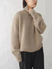 Pull crème à col montant, maille douce, manches longues, silhouette près du corps.