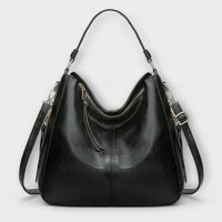 Grand sac hobo noir en cuir, anses hautes, bandoulière réglable, zip central.