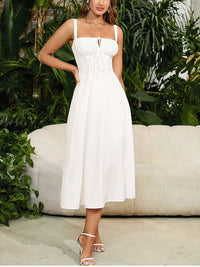 Robe mi-longue blanche corsetée, bretelles fines, corsage froncé et ourlet mi-long