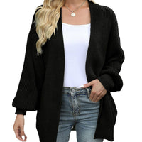 Cardigan Jeannine noir, maille texturée et manches lanterne, porté ouvert.
