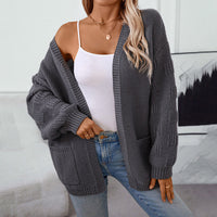 Cardigan ample gris anthracite, manches bouffantes en maille texturée et poches sur le devant