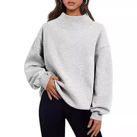 Sweat col roulé oversize gris clair, manches bouffantes, coupe ample.