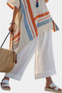Blouse rayée multicolore avec poche poitrine, col rond, manches courtes asymétriques