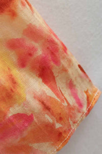 Détail ourlet de robe orange à motif floral, couture et bord renforcé