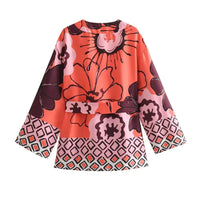Haut ample rouge à motifs floraux, manches évasées, encolure ronde