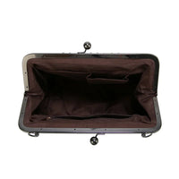 Sac à main vintage ouvert : intérieur bordeaux, fermoir encadré et bouton sphérique