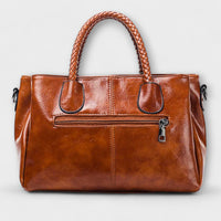 Sac polochon en cuir cognac, face avant avec poches zippées et bandoulière