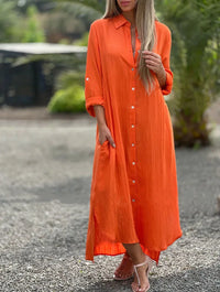 Robe-chemise orange à col chemise, boutonnée, fente près de l’ourlet.