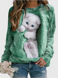 Sweat en tissu peluche vert, motif chat blanc aux yeux bleus sur le devant.