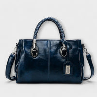 Sac polochon en cuir bleu, poignées tressées, poche zippée et bandoulière