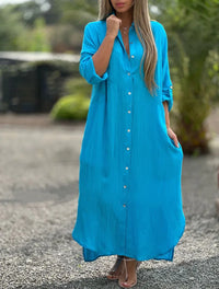 Robe-chemise turquoise à manches trois-quarts, boutonnée sur toute la longueur.