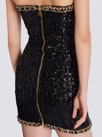 Robe bustier noire à sequins, fermeture centrale dorée et bordure pailletée