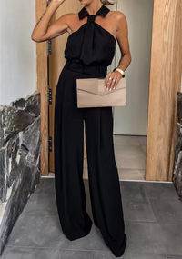 Combinaison noire col halter noué, taille ceinturée et jambes larges