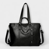 Grand sac en cuir noir, vue de face avec bandoulières et poche zippée