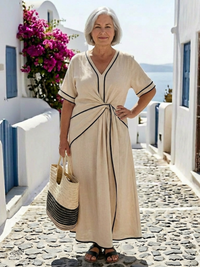 Robe midi manches courtes beige clair, encolure V, passepoil noir et nœud frontal