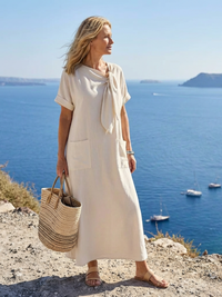 Robe longue beige à col rond noué, manches courtes, coupe ample avec poche avant.