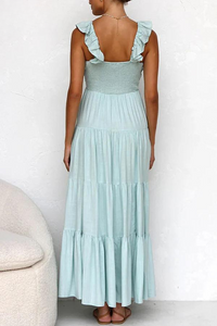 Robe longue bleu clair vue de dos, bretelles à volants, jupe ample à niveaux