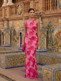 Robe longue sans manches rose fuchsia à fleurs, encolure ronde, coupe ajustée.