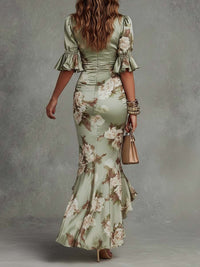 Robe longue asymétrique vert clair à fleurs, effet froncé au buste, manches bouffantes.