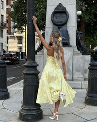 Robe midi jaune évasée, bretelles fines, décolleté plongeant, tissu texturé