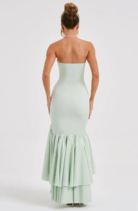 Robe longue sans manches vert menthe, dos nu, volants superposés au bas.