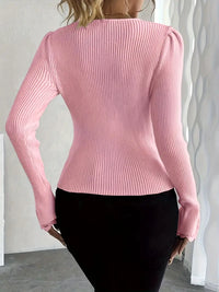 Pull col V texturé rose au dos, manches longues côtelées